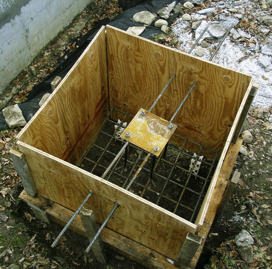 The form for the pad supporting the post in the garage